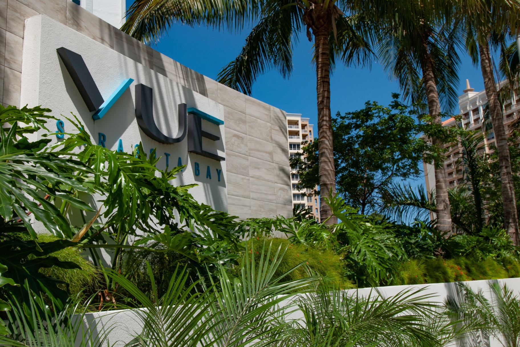 The Westin Sarasota — Vue Sarasota Bay monument sign with tropical landscaping and palm-lined approach