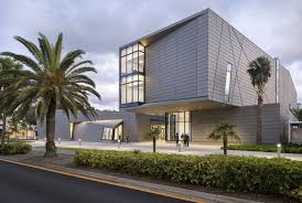 Exterior view of Ringling College academic building with palm-framed approach